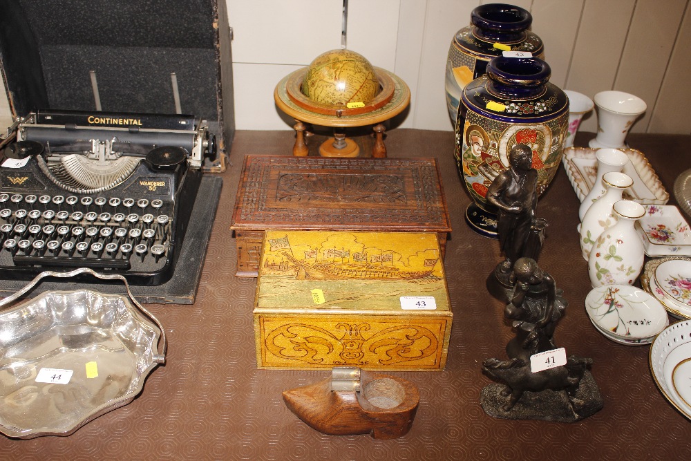 A small desk globe; two boxes; and an ash tray in