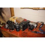 A quantity of various cameras and lenses