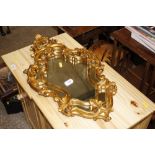 A gilt framed Rococo design wall mirror