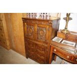 A carved oak drinks cabinet