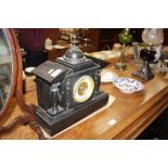 A late Victorian black slate two hole mantle clock