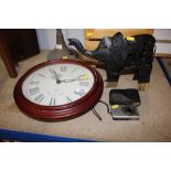 A Westminster wall clock; a metal elephant; a cand