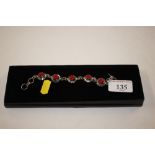 A boxed silver and red stone bracelet, stamped 925