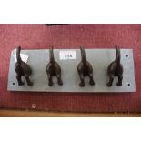 A set of dog tail coat hooks on slate base (126)