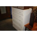 A white laminate chest of five drawers