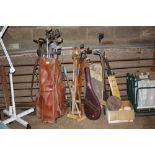 A collection of various golf clubs - some wooden s