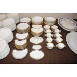 A quantity of blue and gilt bordered dinnerware, s
