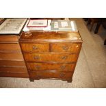 A walnut chest of two short and three long drawers