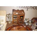 An early 20th Century oak and glazed smokers cabinet