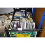 A crate containing various CDs; cassette tapes etc