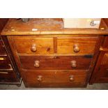 A Victorian stripped pine chest of two short and t