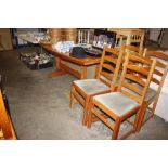 A teak kitchen dining table and four matching ladder back chairs