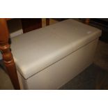 A faux leather upholstered ottoman