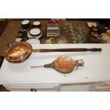 A pair of antique copper cased bellows; and a copper warming pan with turned wooden handle