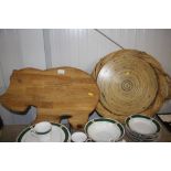 A chopping board in the form of a hippopotamus; and a wicker twin handled tray