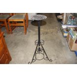 A black metal plant stand