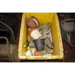 A large plastic crate with contents; a flower pot,