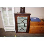 A Georgian oak hanging corner display cabinet