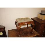 A walnut dressing stool with needlepoint upholster