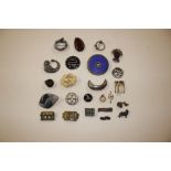 An ivory brooch and various white metal brooches e