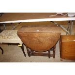 An antique oak gate leg tea table