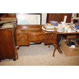 A walnut serpentine shaped writing desk