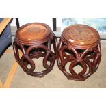 A pair of oriental hardwood barrel seats