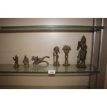 Three oriental brass figures; a beetle nut cutter;