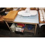 A Formica topped table and two chopping boards