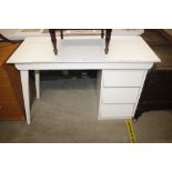 A white painted desk fitted three drawers