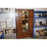 A mirror fronted single door wardrobe fitted single drawer below lacking cornice