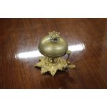 An ornate brass reception bell