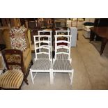 Six painted ladderback dining chairs (four white and two black)