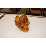 An amber coloured skull ornament