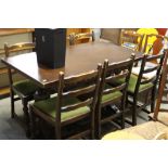 A draw leaf refectory style dining table; and six