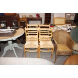 A set of four pine and rush seated kitchen dining