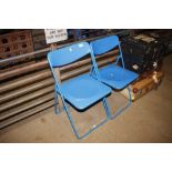 Two blue folding chairs