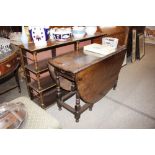 An antique oak gate leg dining table fitted single