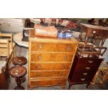 A walnut chest of five drawers on cabriole support