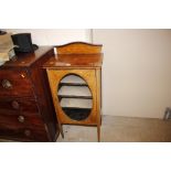 An Edwardian mahogany and inlaid glazed music cabi