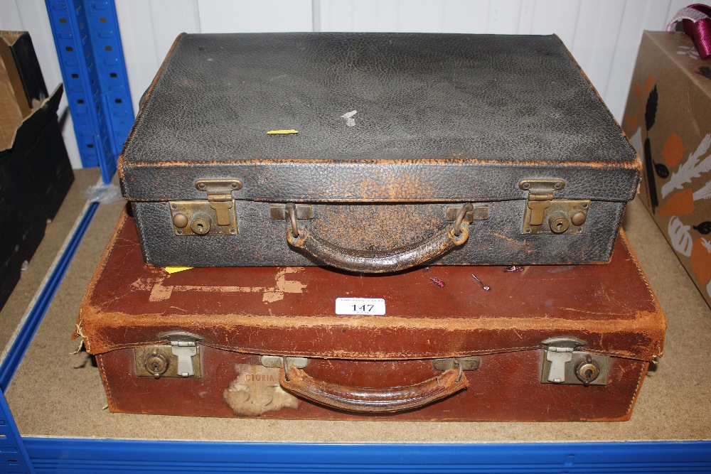 Two small leather suitcases