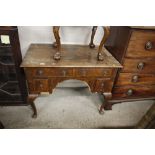 An antique walnut lowboy - in need of restoration