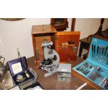 A Beck of London microscope and accessories in fit