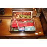 A wooden box of Meccano, complete with instruction