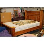 A pine framed king size bed with pocket spring mat