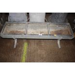 A galvanised three section feed trough