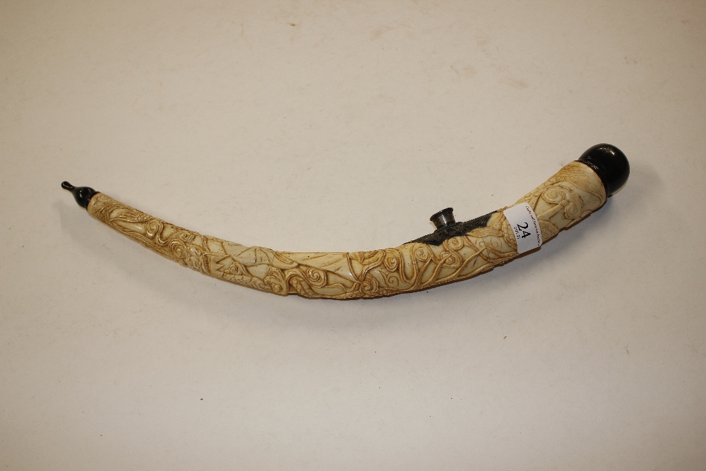A carved ivory opium pipe