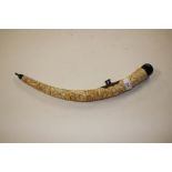 A carved ivory opium pipe