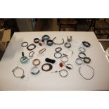 A quantity of various bangles; two silver and agate bracelets; a cigarette holder; costume jewellery