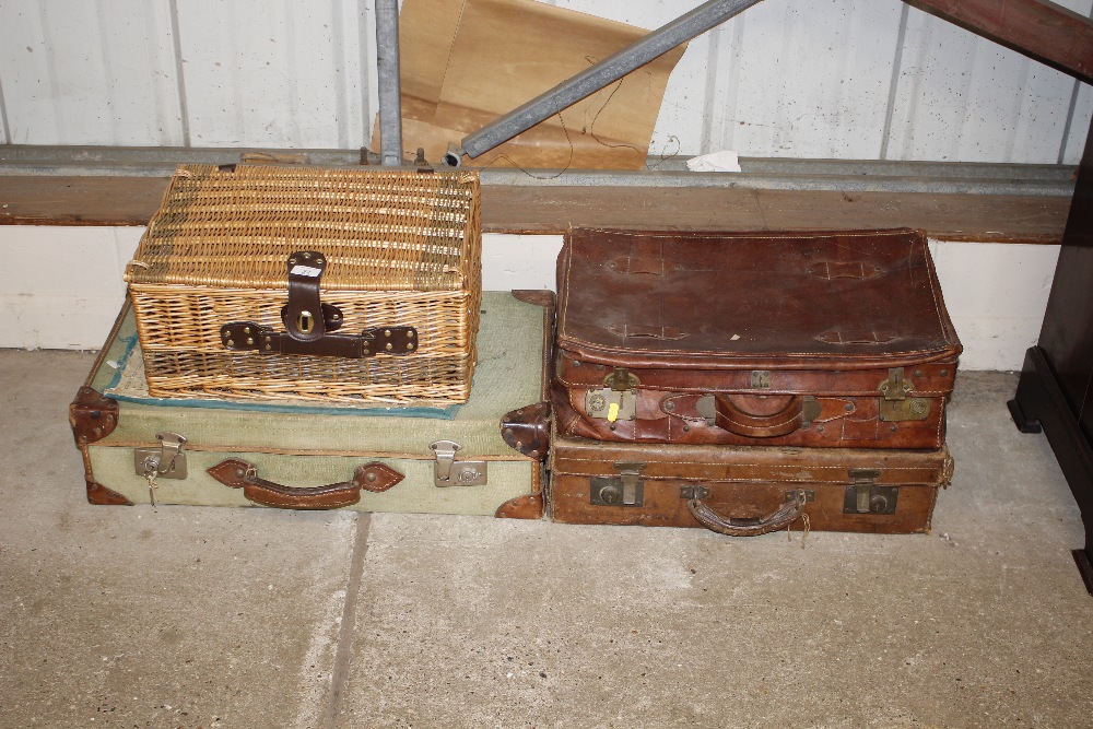 Three vintage suitcases and a wicker hamper